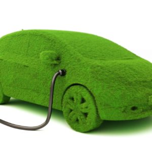 16174506 - alternative power concept eco car . grass covered car plugged into power supply on a white background.