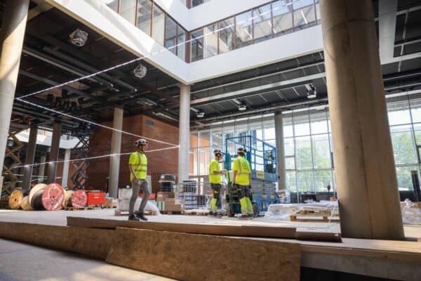 Bilde av Gjelan i OneCo, og to andre som samarbeider på jobb på livsvitenskapsbygget